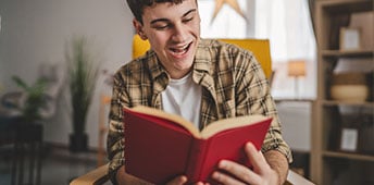 Excited Young Man Reading Book